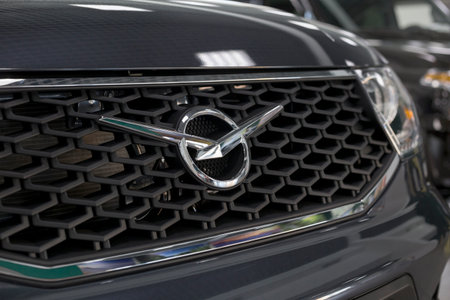 Russia, Izhevsk - August 20, 2021: UAZ showroom. UAZ logo on a bumper of new UAZ Patriot car in dealer showroom. Sollers automotive group. Modern transportation.のeditorial素材