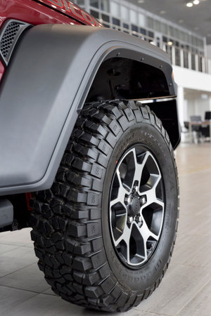 Russia, Izhevsk - March 4, 2022: Jeep showroom. The wheel of Wrangler Unlimited off-road car. Alloy wheel and BFGoodrich tire. famous world brand. modern transportation.のeditorial素材