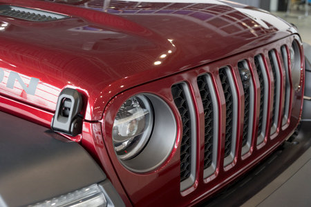 Russia, Izhevsk - March 4, 2022: Jeep showroom. Bumper of a new off-road. Wrangler Unlimited. Elegant round headlamps. Off-road vehicles. Alliance Stellantis. Cropped image. Modern transportation.のeditorial素材