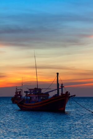 the fishing boat at the ocean, in the eveningの写真素材