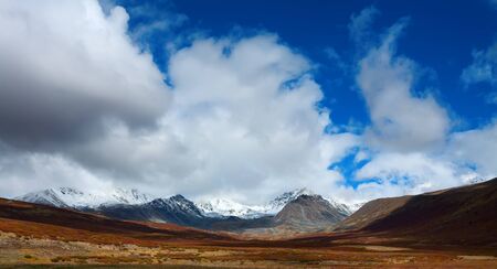 mountain top with snow and ice  Clouds over a glacier in autumn day の写真素材