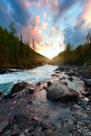 the sun in a taiga with the blue riverの写真素材