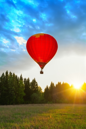 Red balloon in sun beamsの写真素材