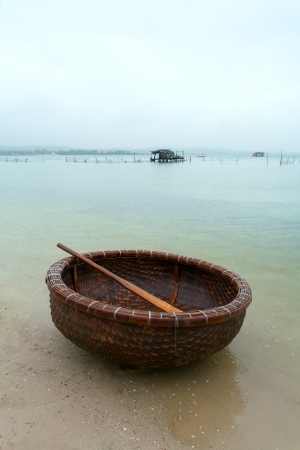 fishing basket on the river bankの写真素材