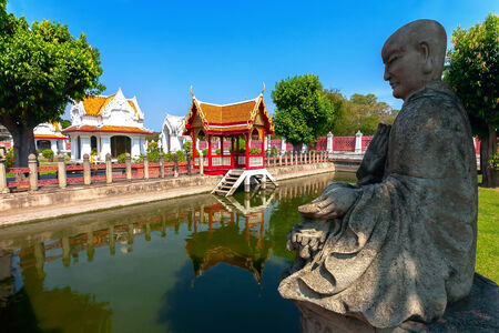 Architecture of the Buddhist temple in park with sculpturesの写真素材