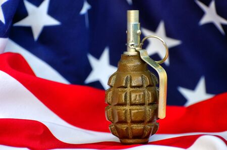 Hand grenade and and USA flag の写真素材