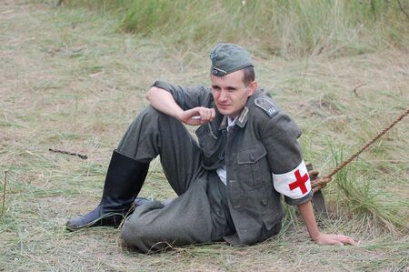 CHERNIGOW, UKRAINE - AUG 29: A member of Red Star military history club wears historical German uniform during historical reenactment of WWII, August 29, 2010 in Chernigow, Ukraine のeditorial素材