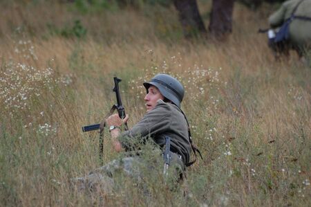CHERNIGOW, UKRAINE - AUG 29: A member of Red Star military history club wears historical German uniform during historical reenactment of WWII, August 29, 2010 in Chernigow, Ukraine のeditorial素材