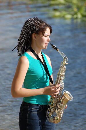 Girl with saxophone の写真素材