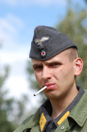 CHERNIGOW, UKRAINE - AUG 29: Member of Red Star military history club wears historical German uniform during historical reenactment of WWII, August 29, 2010 in Chernigow, Ukraine のeditorial素材