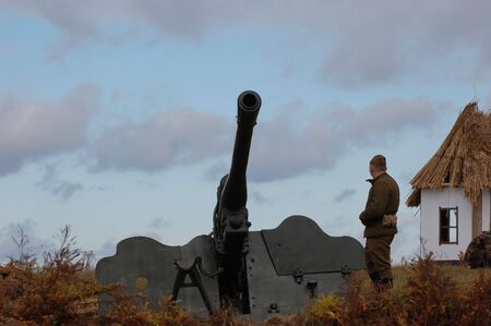 KIEV, UKRAINE - NOV 7: A members of military history club wears historical Soviet uniform & air defense cannon during historical reenactment of WWII,November 7, 2010 in Kiev, Ukraine のeditorial素材