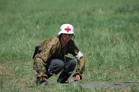 KIEV, UKRAINE - MAY 10 : member of Red Star history club wears historical military German paramedic uniform during historical reenactment of 1945 WWII, May 10, 2010 in Kiev, Ukraine のeditorial素材