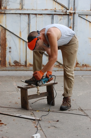 Man works with angular electric grinder. Ukraineの写真素材