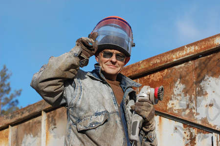 Man works with angular electric grinder  Ukraine の写真素材