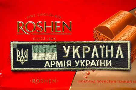 Kiev,Ukraine.Dec 20.Illustrative editorial. Chevron of Ukrainian Army.With logo Roshen Inc. Trademark Roshen is property of ukrainian president Poroshenko.At December 20,2014 in Kiev, Ukraineのeditorial素材