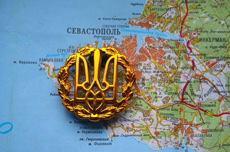 Kiev,Ukraine.JAN 10.Illustrative editorial.Ukrainian army cockade.With map of Sevastopol,Crimea. Former Ukraine.At present time Russia. At January 10,2015 in Kiev, Ukraineのeditorial素材