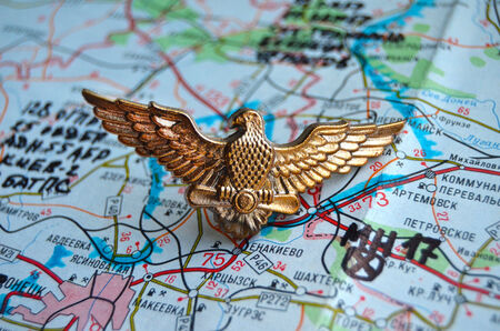 Illustrative editorial.Cockade of Ukrainian air force. Estern Ukraine map with site MH-17 flight crush as background. At January 10,2015 in Kiev, Ukraineのeditorial素材