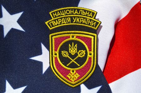 Ukrainian military chevron. With US Flag as background.on April 162015 in Kiev Ukraineのeditorial素材