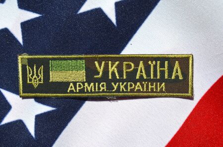 Ukrainian military chevron. With US Flag as background.on April 162015 in Kiev Ukraineのeditorial素材