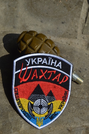 Illustrative editorial.Ukrainian chevron. Police formation Miner. Formation closed by power in Kiev for mass military and civil crimes.July 14,2015 in Kiev, Ukraineのeditorial素材