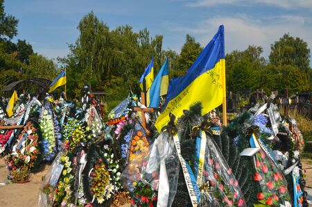 AUG13,2015 in KIEV,UKRAINE .Lesnoye Forest Cemetery.Graves of Ukrainan army and nationalist formations soldiers died during Ukrainian Civil War 2014-15 at Donbas. At August 13,2015 in Kiev,Ukraineのeditorial素材