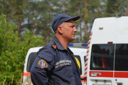 KIEV, UKRAINE - September 03, 2015: Ukrainian rescue and fireman team in the forest. A lot of fire...