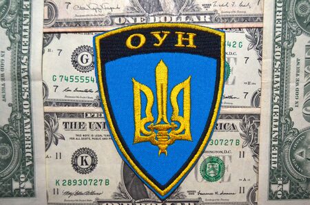 Kiev, Ukraine.OCT 19.Illustrative editorial. Chevron of Ukrainian Army.With money background.At October 19, 2015 in Kiev, Ukraineのeditorial素材
