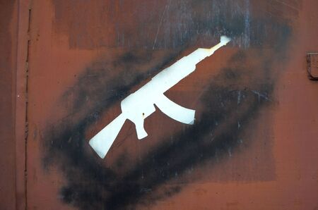 KIEV, UKRAINE - OCT 23, 2015: Colored background.Graffiti on a garage gate -grunge AK 47. October 23, 2015, Kiev, Ukraineのeditorial素材