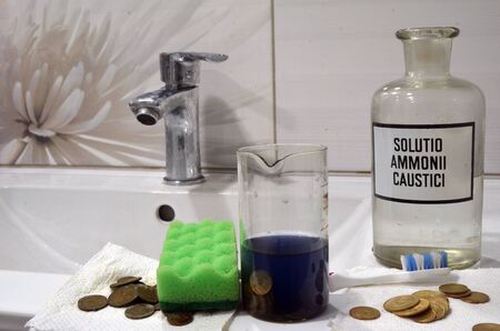 Chemical cleaning of Soviet vintage coins with metal detector near Kiev.Incription (LATIN) - Caustic Ammonia Solutionの写真素材