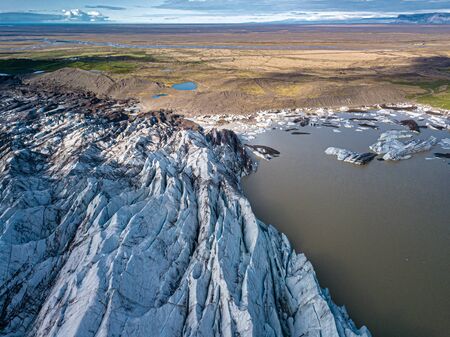 Svnafellsjkull Glacier in Iceland. Top view. Skaftafell National Park. Ice and ashes of the volcano texture landscape, beautiful nature ice background from Icelandの写真素材