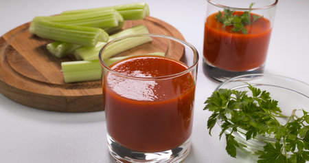 Glasses of tomato juice on a white table. Healthy and vegetarian food conceptの写真素材