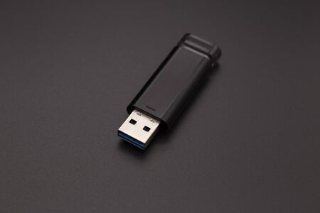 black flash drive on a dark background