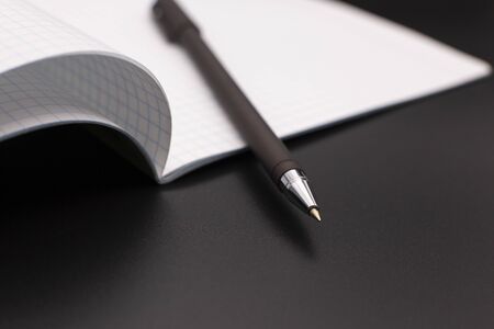 exercise book and fountain pen on a dark background