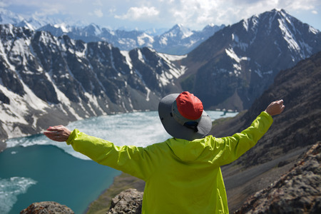 Wonderful mountain landscape and sitting girl (lake, highland, peak, beauty world) Picturesque...