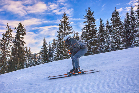 Winter landscape with snow, forest and skiers in Karakol, Kyrgyzstan.の写真素材
