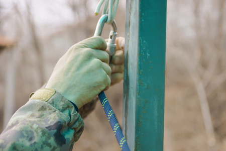 The sportsman hangs up carbine in hook.の写真素材