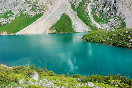 Beautiful mountain turquoise color lake Colculan. Kyrgyzstan.の写真素材