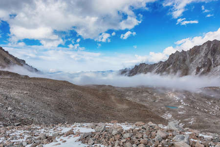 Mountain landscape view in Kyrgyzstan. Rocks, snow and stones in mountain valley view. Mountain...