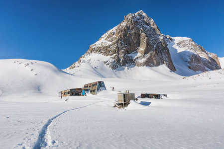 Idyllic winter landscape with hiking trail in the mountains. Rocks, snow and stones in mountain valley view. Mountain panorama.の写真素材