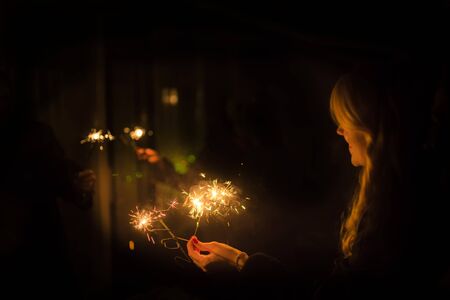 burning sparkler in a woman handの写真素材