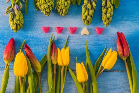 Tulips and hyacinths on a wooden table, heart, love, Valentine's Dayの写真素材