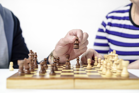 Defocusing, male and female hand move figures on a chessboardの写真素材