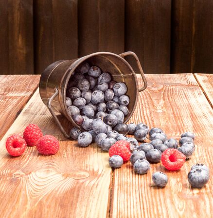 Ealthy mixed fruit, Blueberry. Fresh berries, blackberry, raspberry, on wooden tableの写真素材