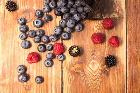 Healthy mixed fruit, Blueberry. Fresh berries, blackberry, raspberry, on wooden tableの写真素材