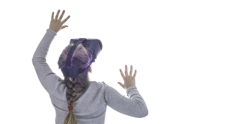 Girl using a virtual reality headset . Isolated on white backgroundの写真素材