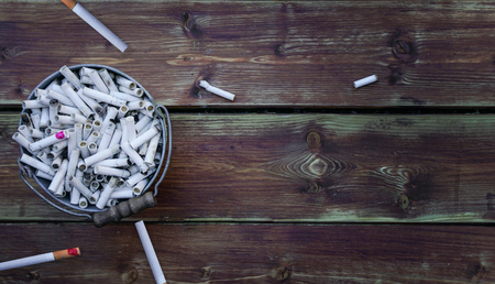 Cigarette butts in Bucketful . Smoking is harmful to healthの写真素材