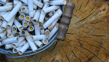 Cigarette butts in Bucketful . Smoking is harmful to healthの写真素材