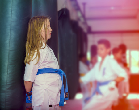 Girl resting after a hard training in karate school. Tired in trainingの写真素材