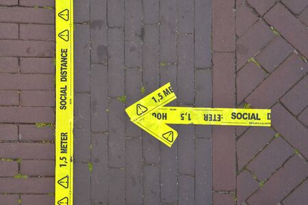 The inscription on the street: keep a social distance 1.5 m. Selective focus. Protection from...