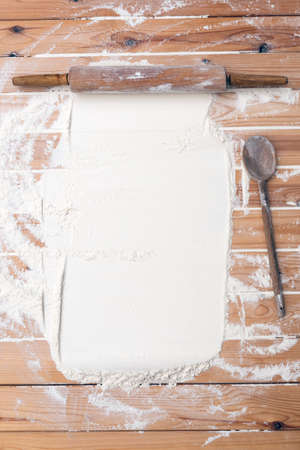 Flour scattered on the wooden table. Flour on the table surface. Baking backgroundの写真素材